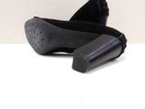 a pair of black shoes that are on a table