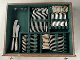 a wooden box with silverware in it on a table