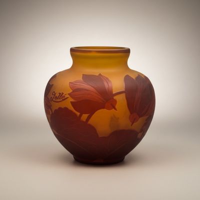 a vase that has a flower on it on a table