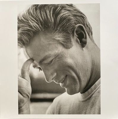a black and white photo of a man holding a cell phone