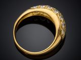 a close up of a gold ring with diamonds on a black background
