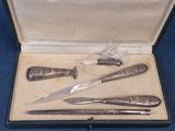 three knives and a knife sharper in a case