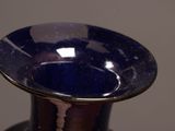 a blue vase that is sitting on a table