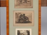 two framed drawings of horses and a man on a horse drawn carriage