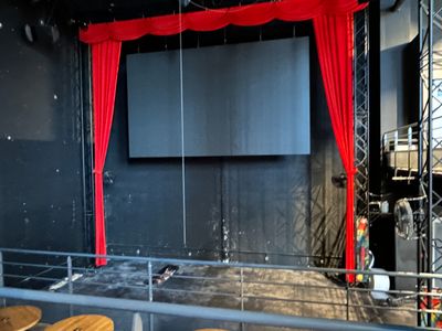 an image of a stage set up with red curtains