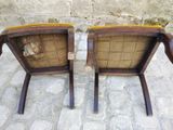 two chairs that are sitting next to each other on a stone floor