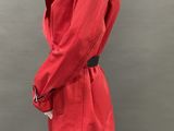 an image of a mannequin dressed in a red coat and black pants
