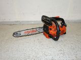 a chainsaw sitting on the floor next to a wall