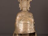 a bronze statue of a woman with a bird on her head