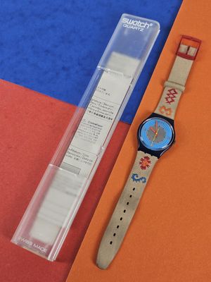 a watch that is sitting next to a piece of paper