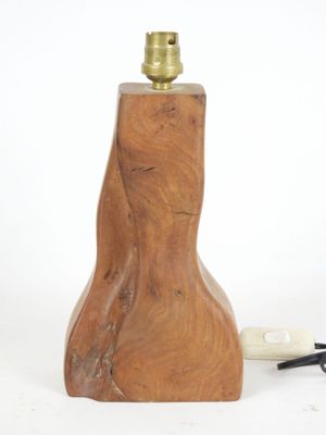 a wooden lamp that is next to a pipe