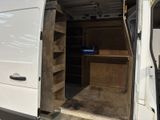 a white van with open doors and shelves in the back