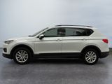 the white volkswagen suv is parked in a parking lot