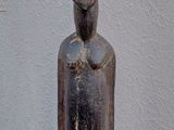statue of a man with a black face on a wooden base