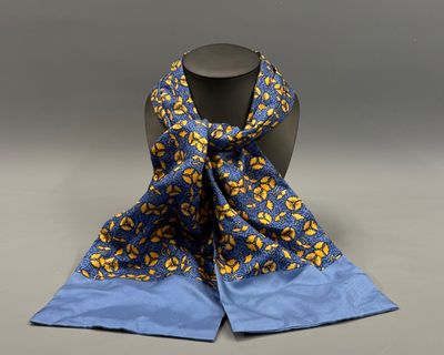 a blue and yellow scarf with yellow flowers on it