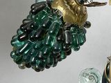 a bird that is sitting on top of a glass vase