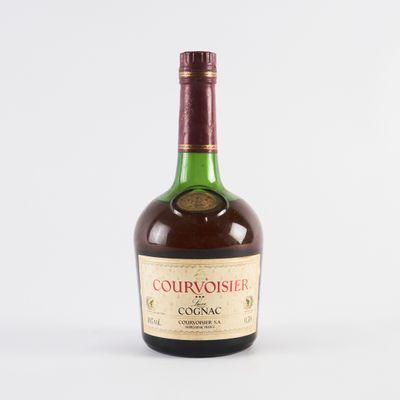 a close up of a bottle of liquor on a white surface