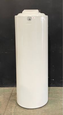 a white water heater sitting on the floor next to a black wall