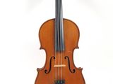 an old violin sitting on top of a white surface