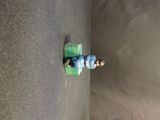 a small figurine of a man sitting on a bench