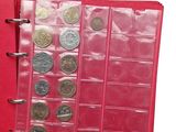 a red binder with a bunch of coins in it