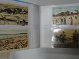 a person holding a book open to show pictures of people on the beach