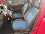 a red car with blue seats in the back of it