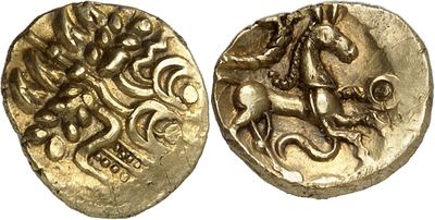 a gold coin with a horse and rider on it