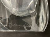 a clear glass vase with a black cat inside of it