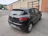 the rear end of a black car parked in a parking lot