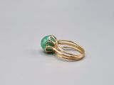 an 18k gold ring with a green jade stone
