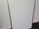 a white board leaning against a wall in a room