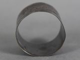 a close up of a ring on a table with a gray background