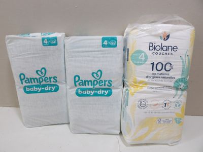 three packs of pampers baby diapers sitting on top of a counter