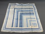 an old blue and white handkerchief with squares on it