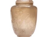un vase en verre muni d'un couvercle, posé sur une surface blanche