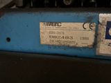 a close up of a blue machine with a label on it