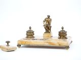 a statue of a man sitting on top of a marble table