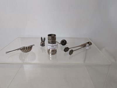 a glass display case with silver objects on it