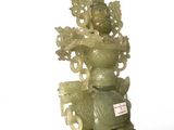 a green vase that is sitting on top of a stand
