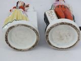 pair of porcelain figurines of a man and a woman in a car