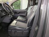 the interior of a car with the door open and the driver ' s seat down
