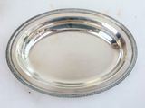 silver plate with beaded edge on a white surface