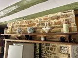 many vases on the shelf above the stove