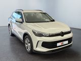 the white volkswagen suv is parked in a room with a black floor