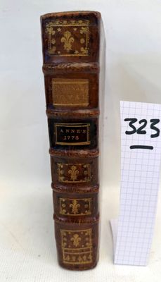 a stack of books sitting on a table next to a price tag