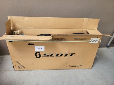 a cardboard box with a pair of shoes inside of it