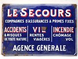 blue and red sign on a white wall with french writing
