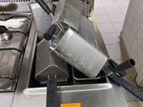 a silver stove top with a bunch of fryers on top of it