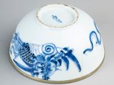 a blue and white bowl with a dragon design on it